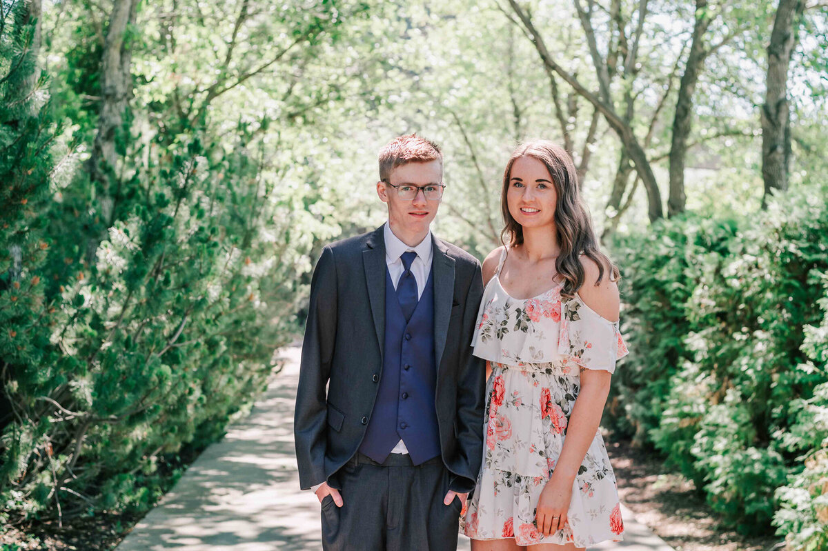Standing with his sister. 