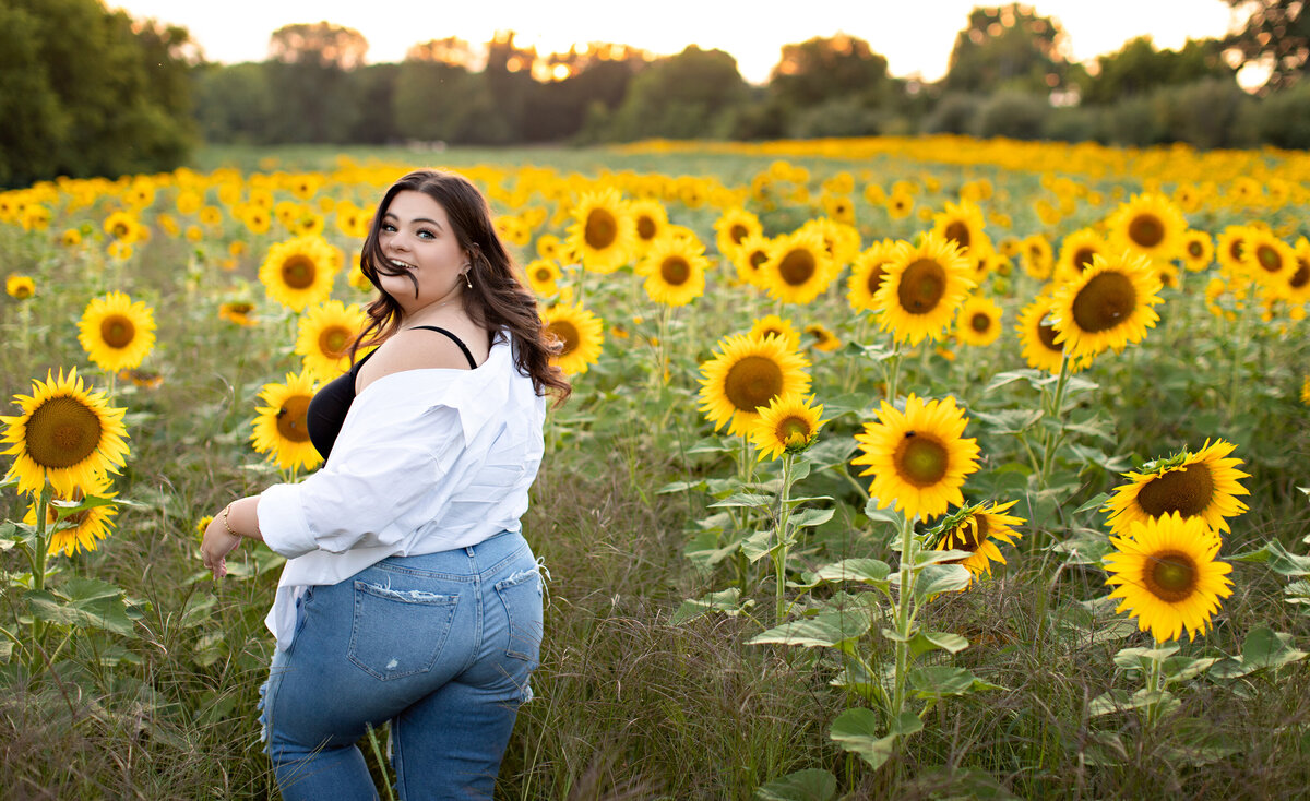 brunette-senior-in-sunflower-field-angela-brown-photography-brighton-howell-michigan