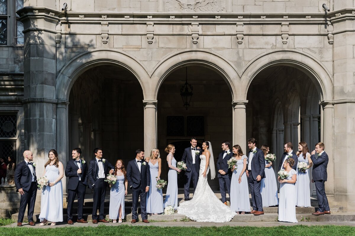 Wedding party standing outside arches at Long Island wedding