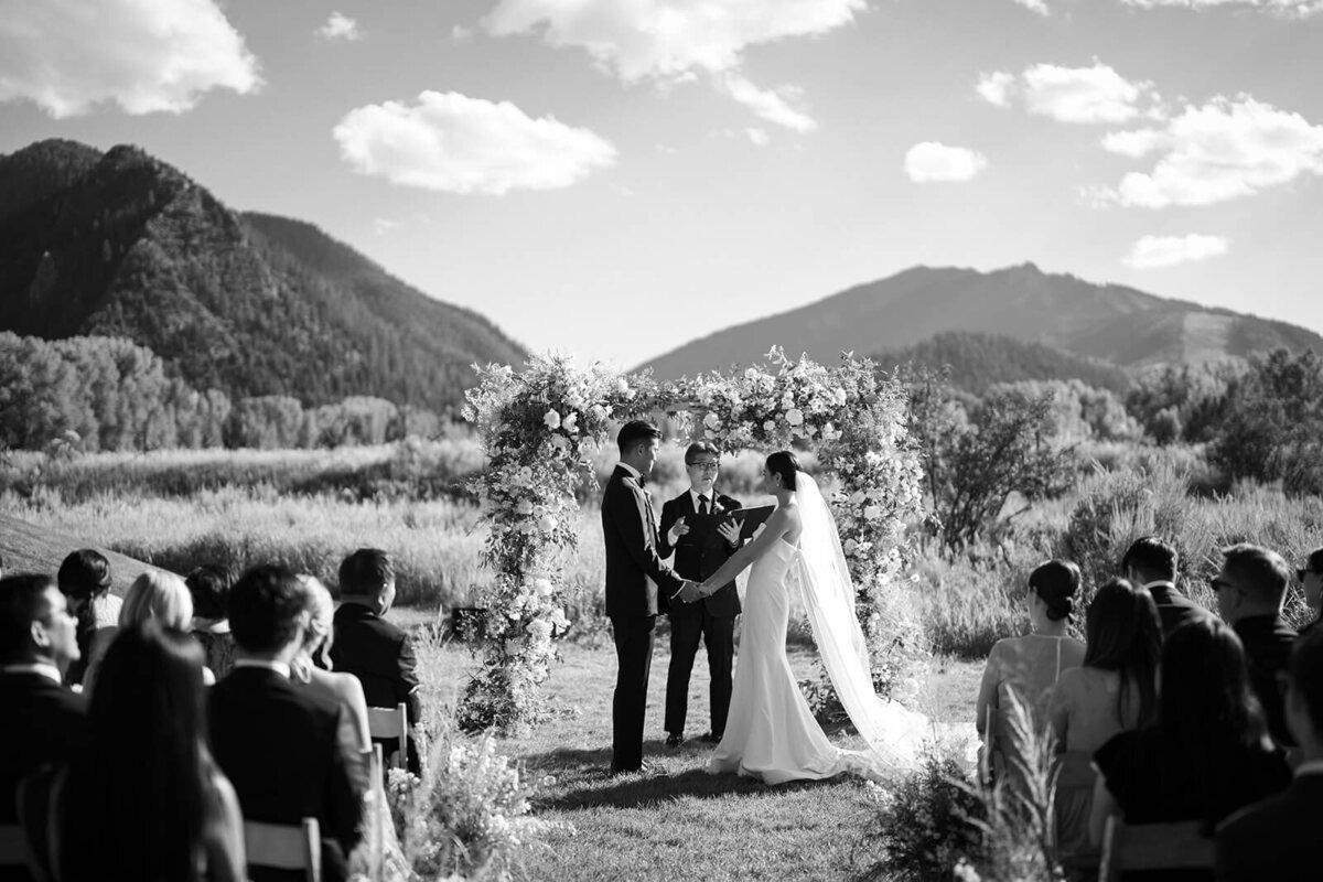 Bride and Groom share vows before the charmingly picturesque view of the Aspen Meadows Resort.