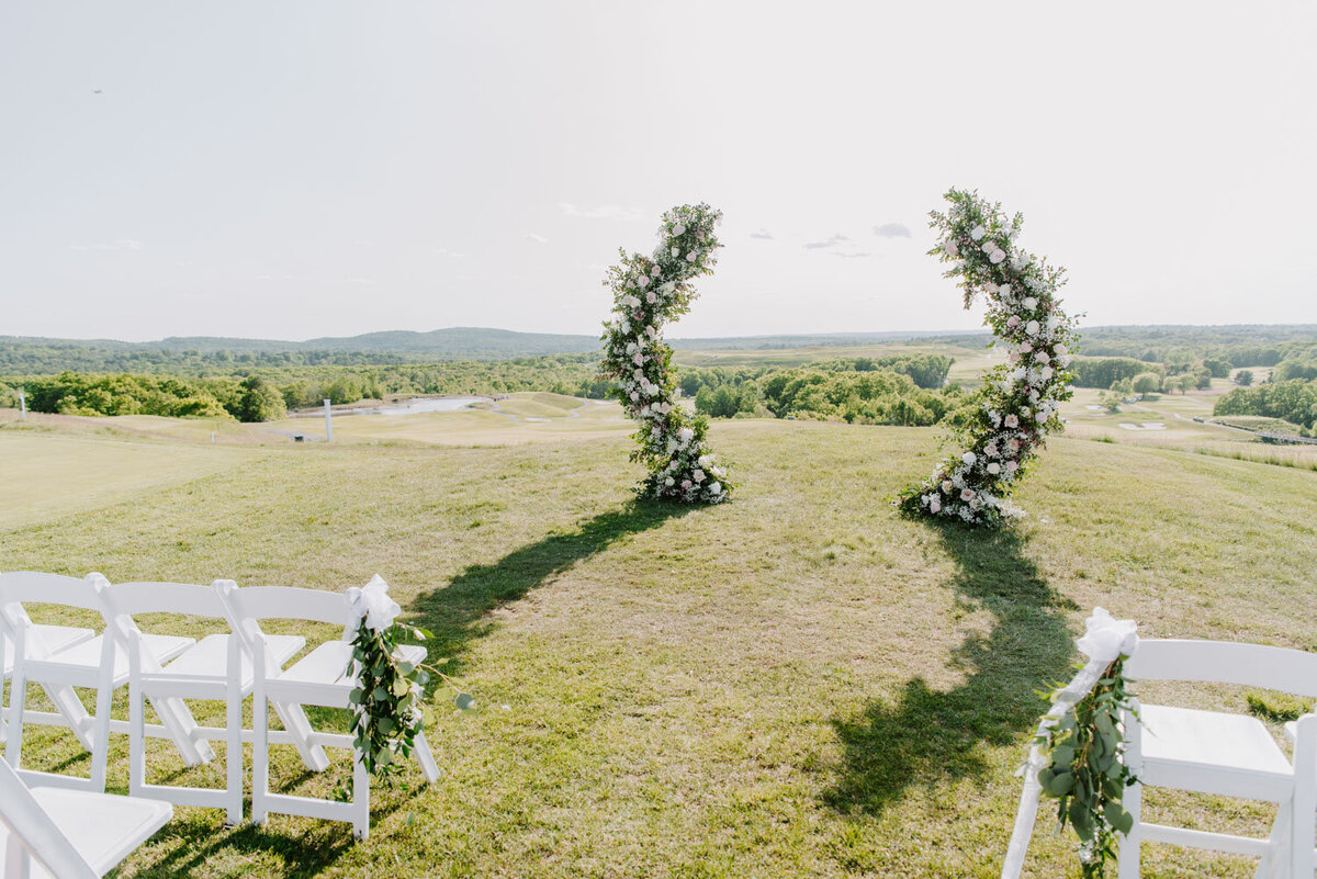 Elegant outdoor wedding reception with floral arch
