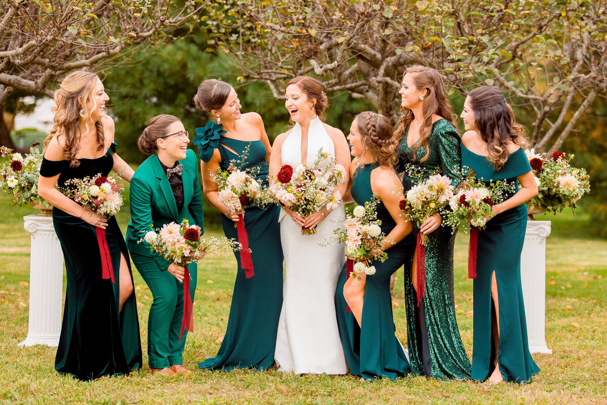 Bride laughs with her bridesmaids during her micro-wedding in Massachusettes.
