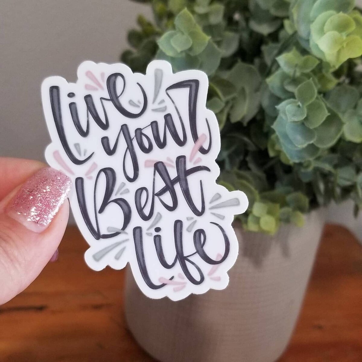 Custom hand lettered sticker with words "live your best life"