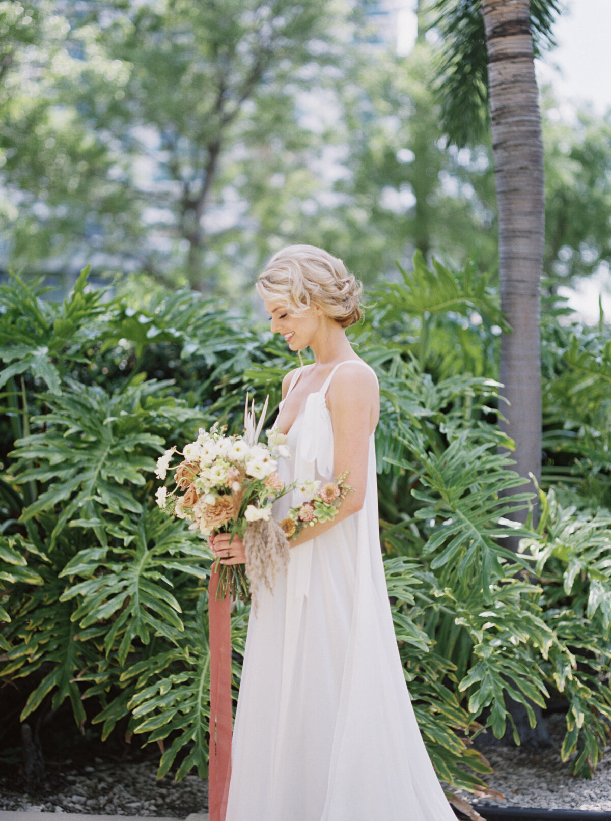 A bride waits with her big bouquet.