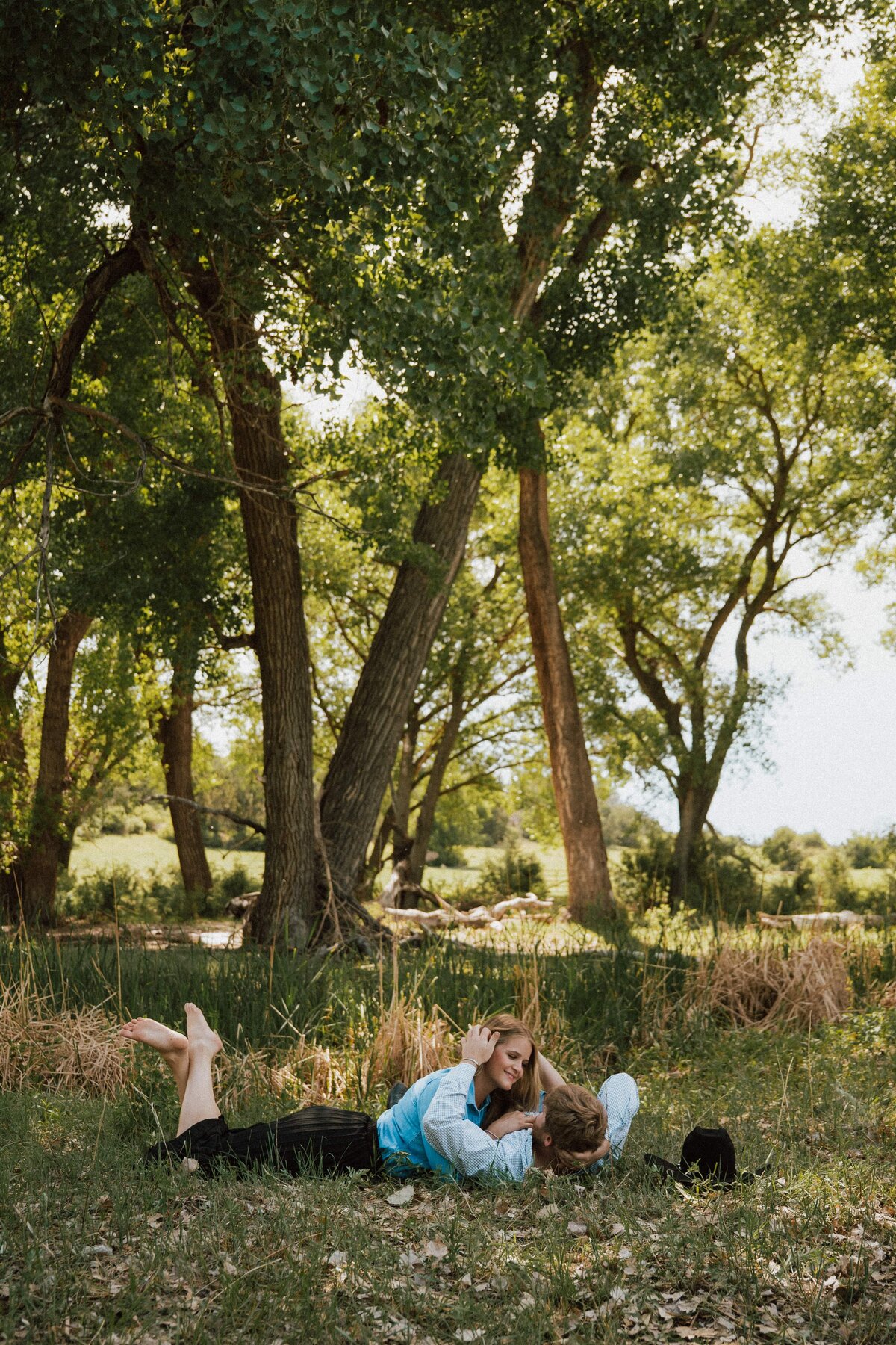 engagement-couple-laying-grass