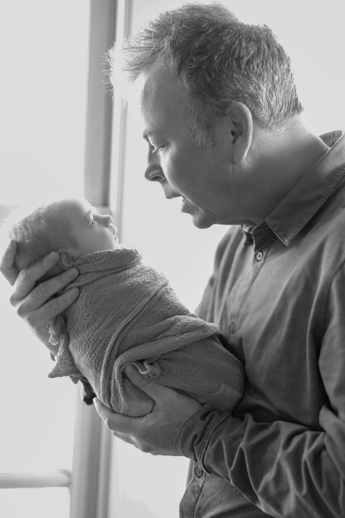 intimate moment between newborn and father