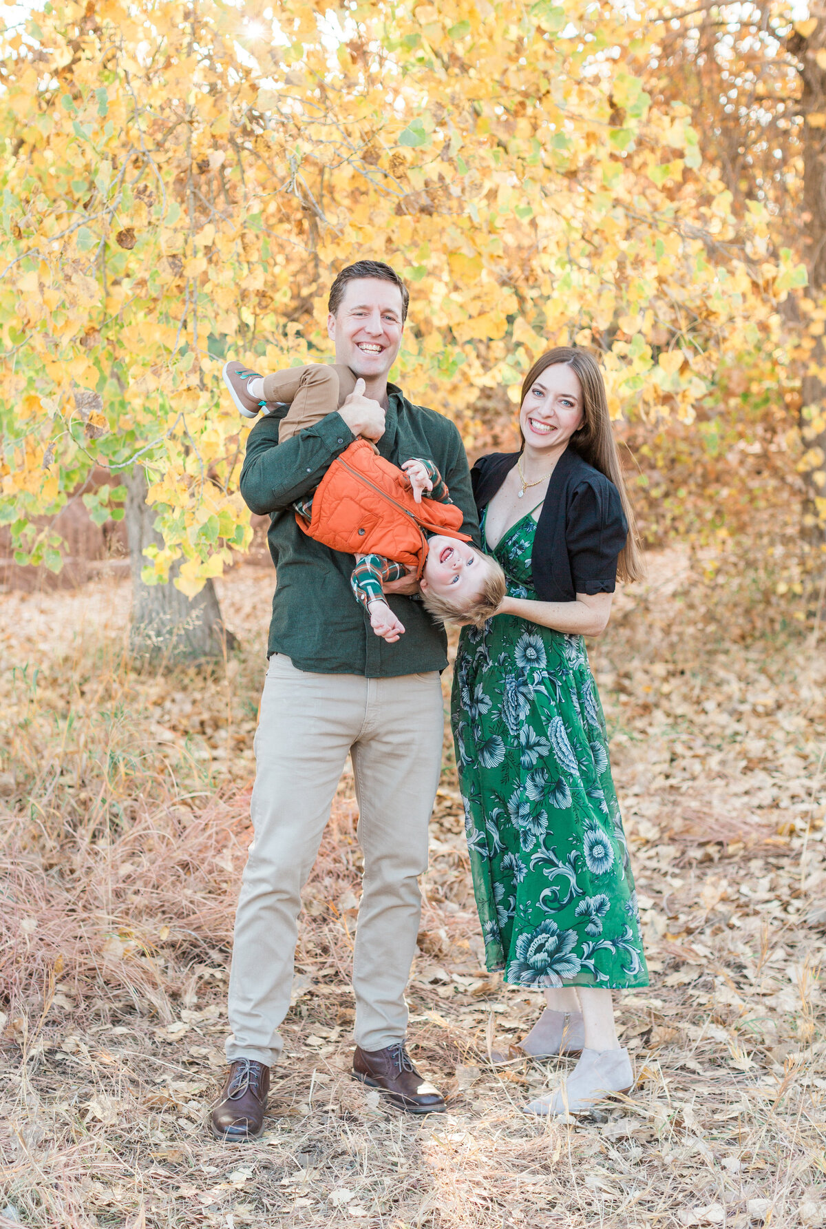 A family with fall leaves during their mini session in Parker