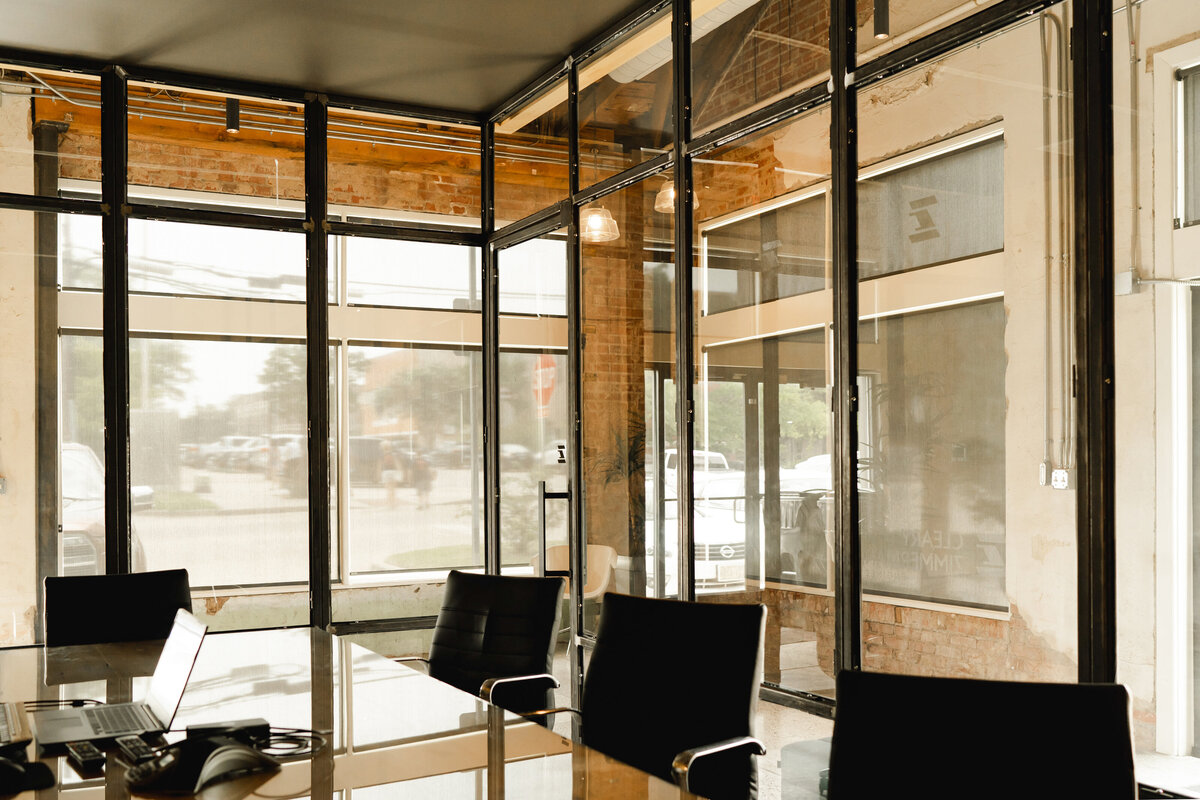 office conference room with glass storefront black mullion walls