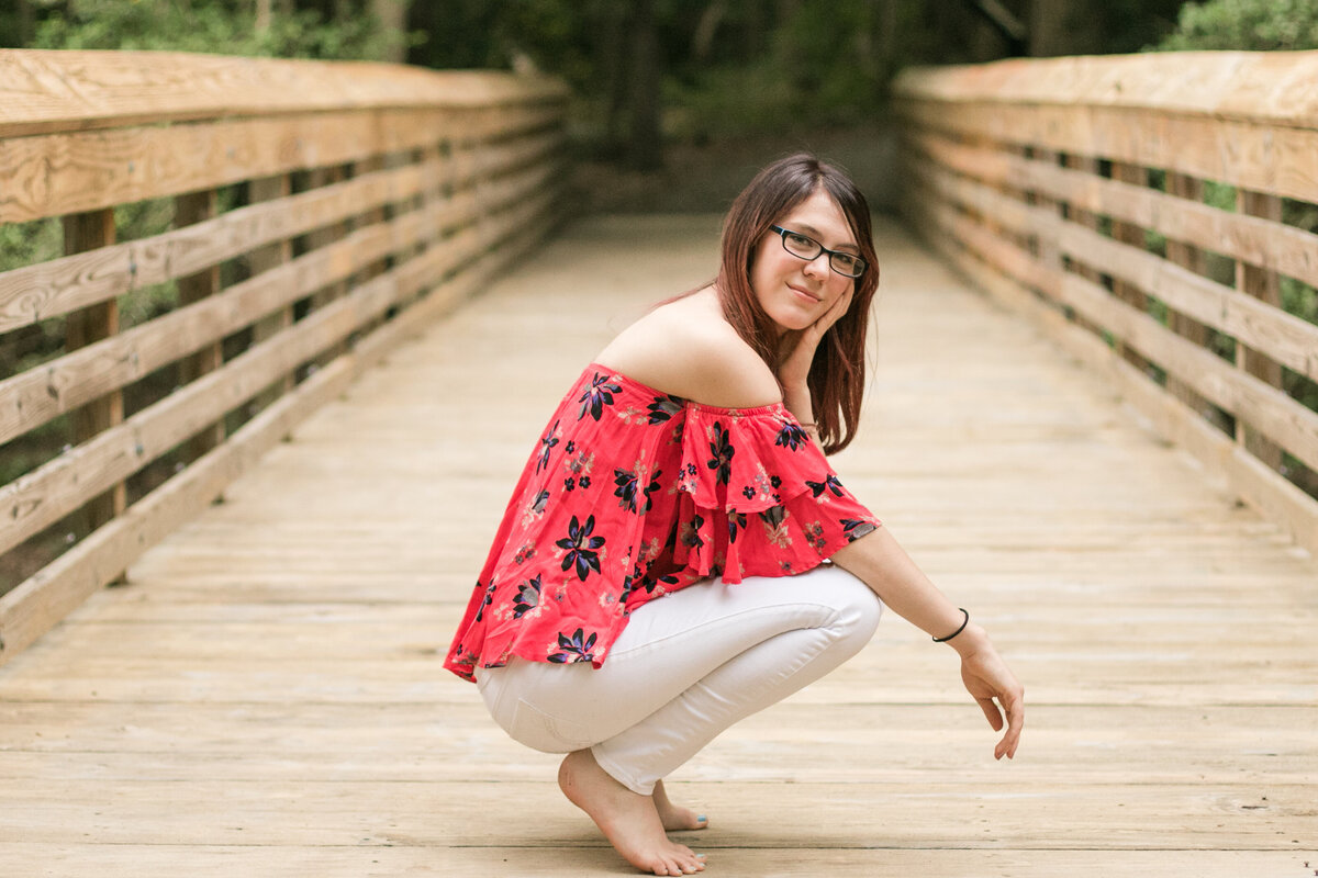 senior portrait on wood bridge