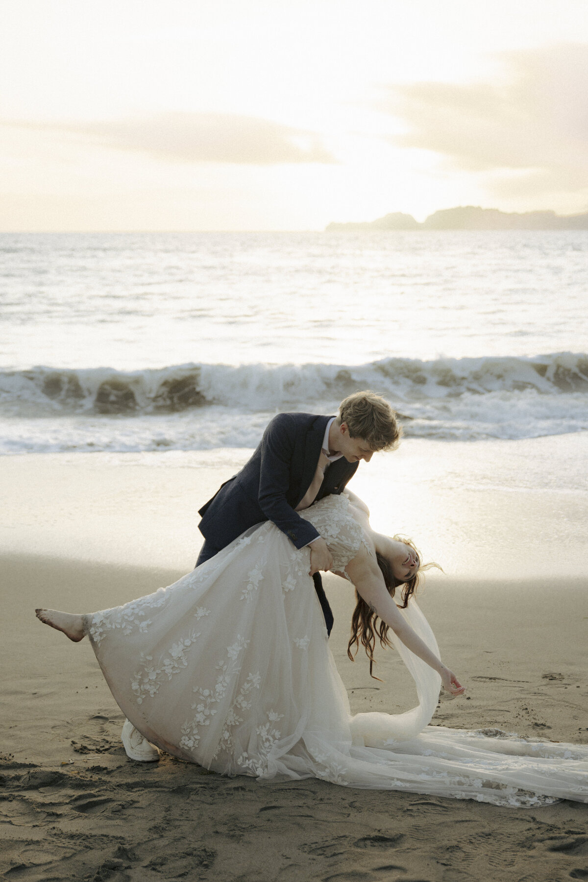 Bride and Groom at Marshall's Beach in San Francisco, California at sunset