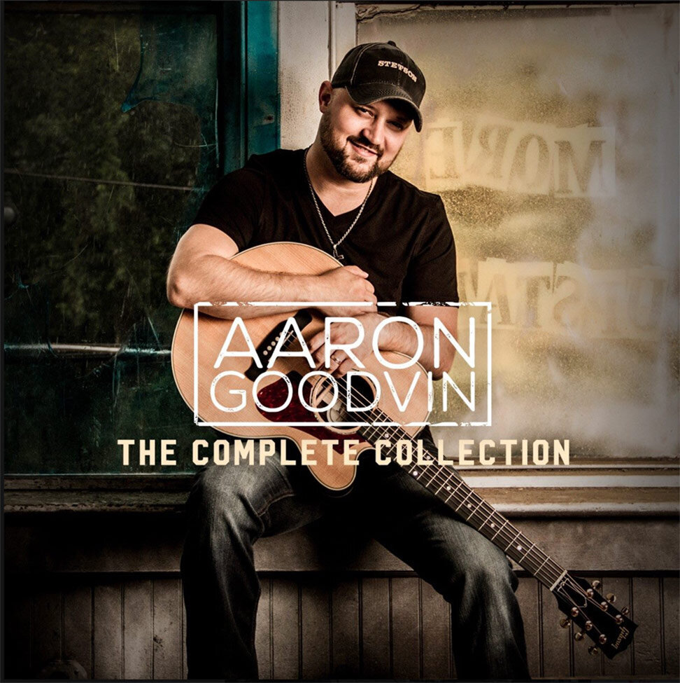Album Cover Aaron Goodvin Title The Complete Collection Singer sitting on windowsill holding guitar in lap