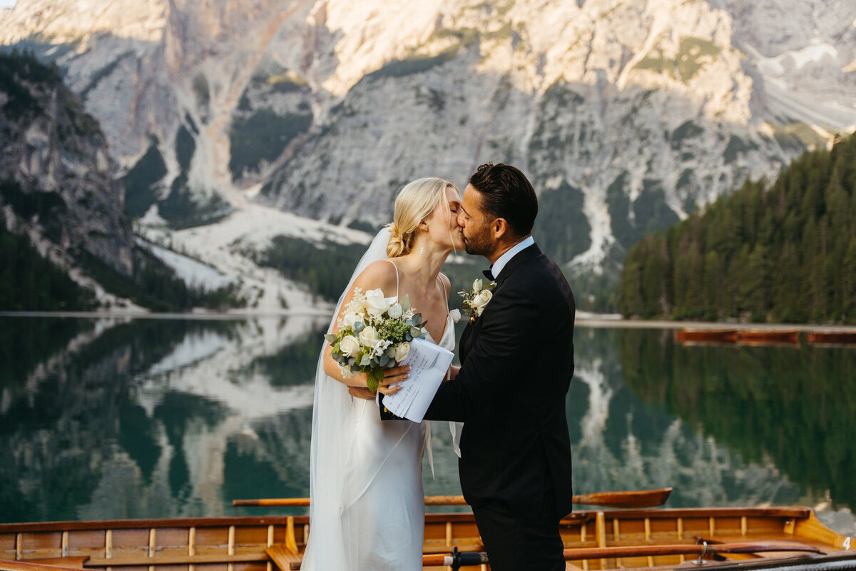 Romantic kiss between bride and groom at Lago di Braies