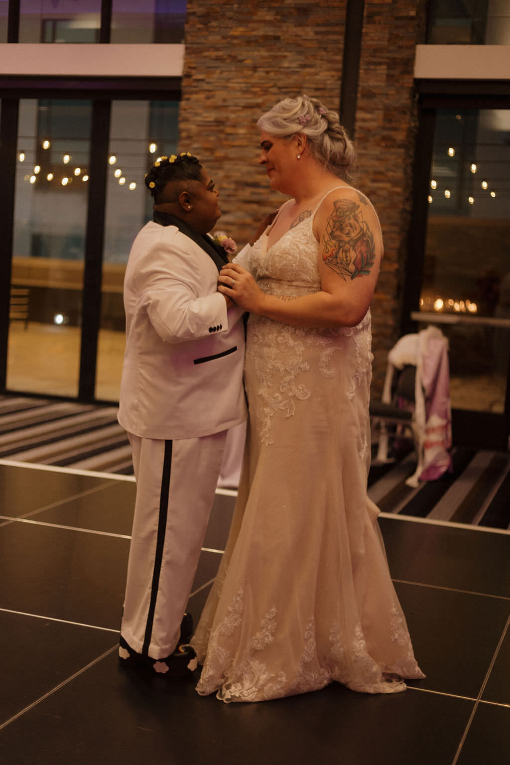 A married couple dancing together at their reception.