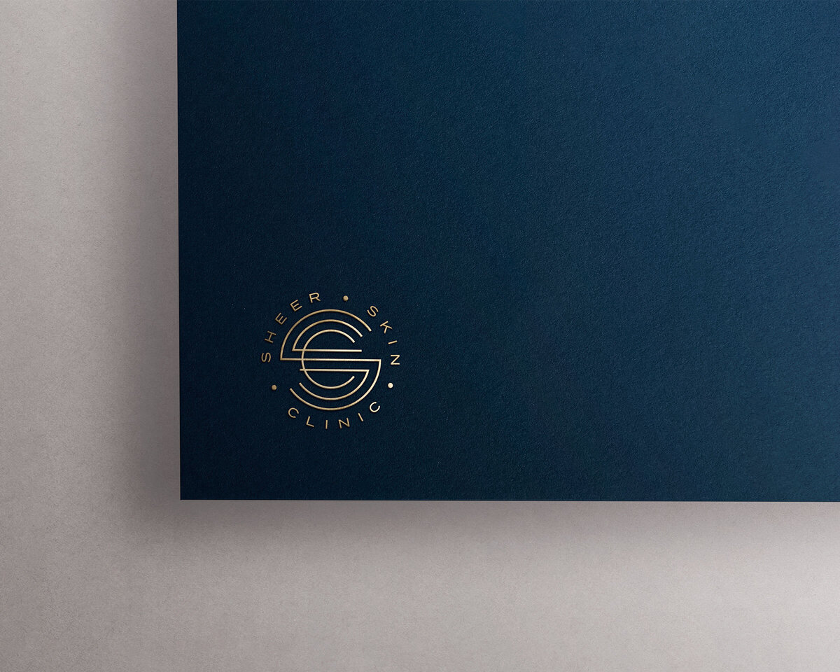 Navy and gold brand identity for a London-based luxury skincare clinic.