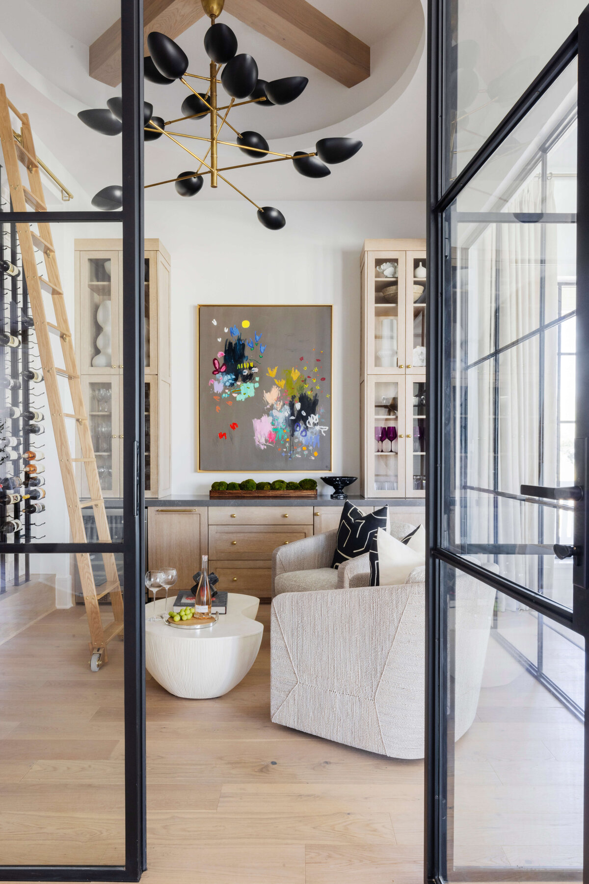 window panelled door overlooking wine cellar with modern art