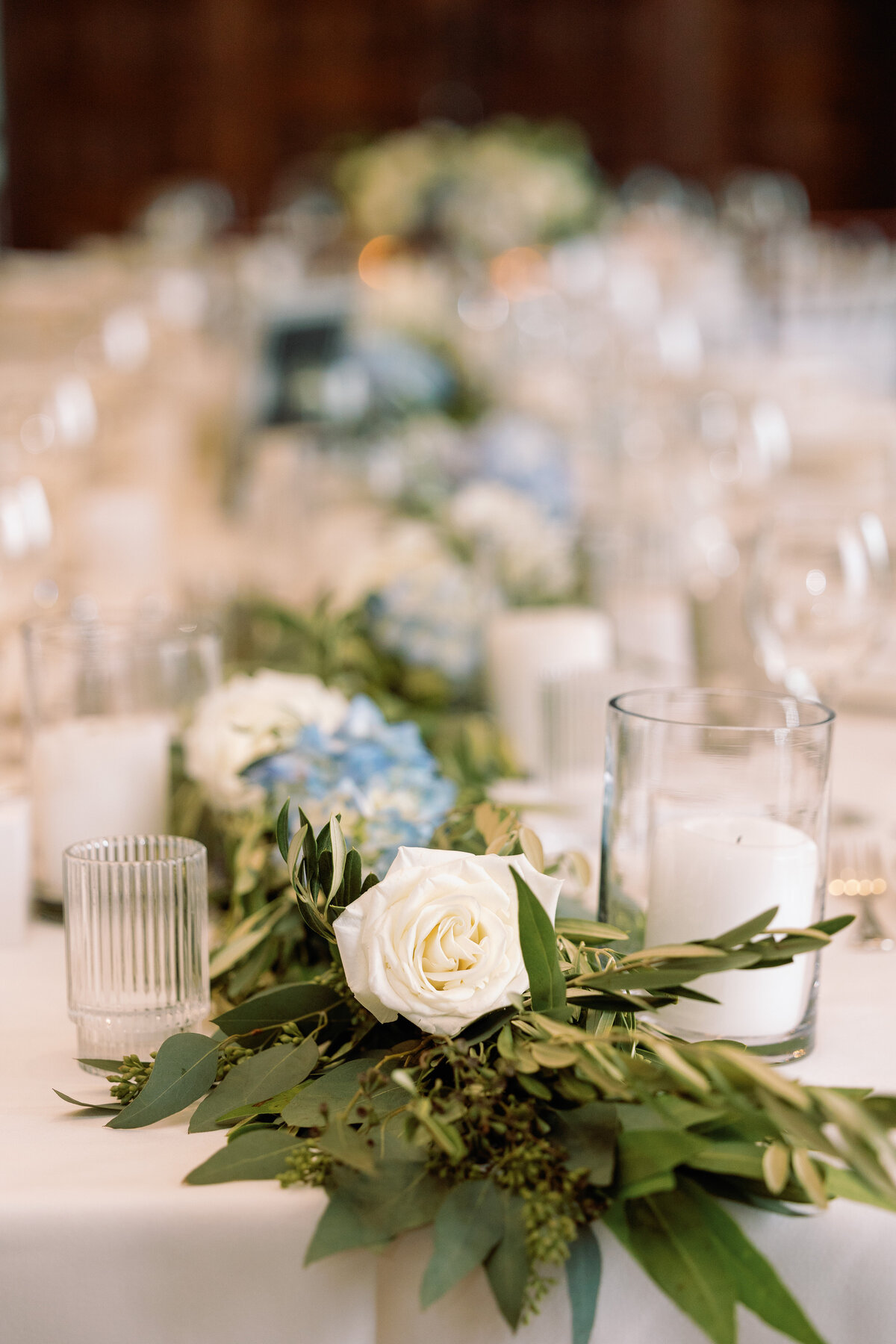 White Rose on a table  with blue hydranigeas