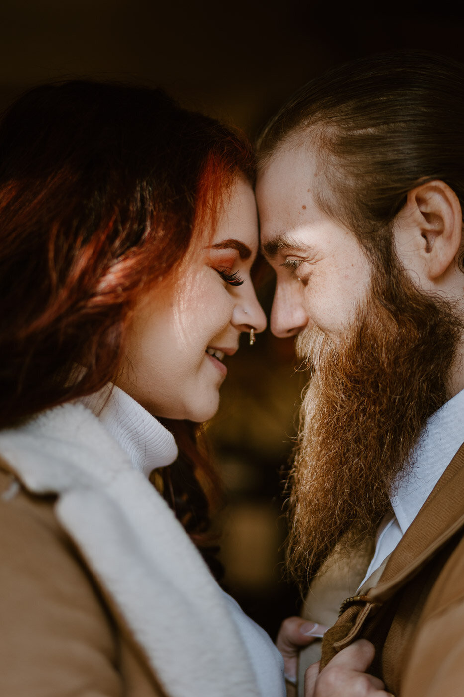 An image captured by Portland Engagement Photographers  of happy engaged couple touching foreheads at sunset