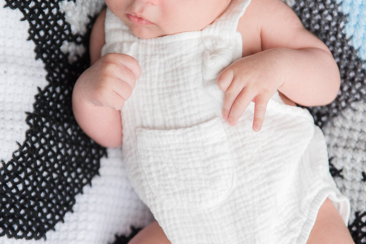 baby hands close up white romper