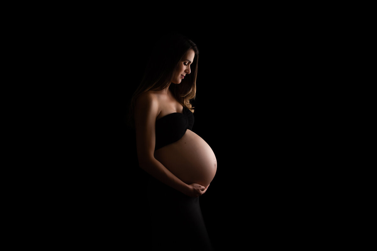 Maternity photo with a black background