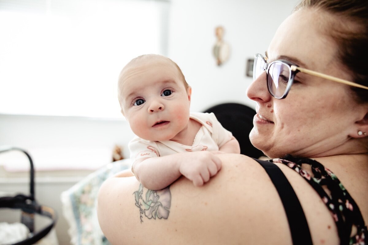A new mama holds her 2 day old baby in her arms