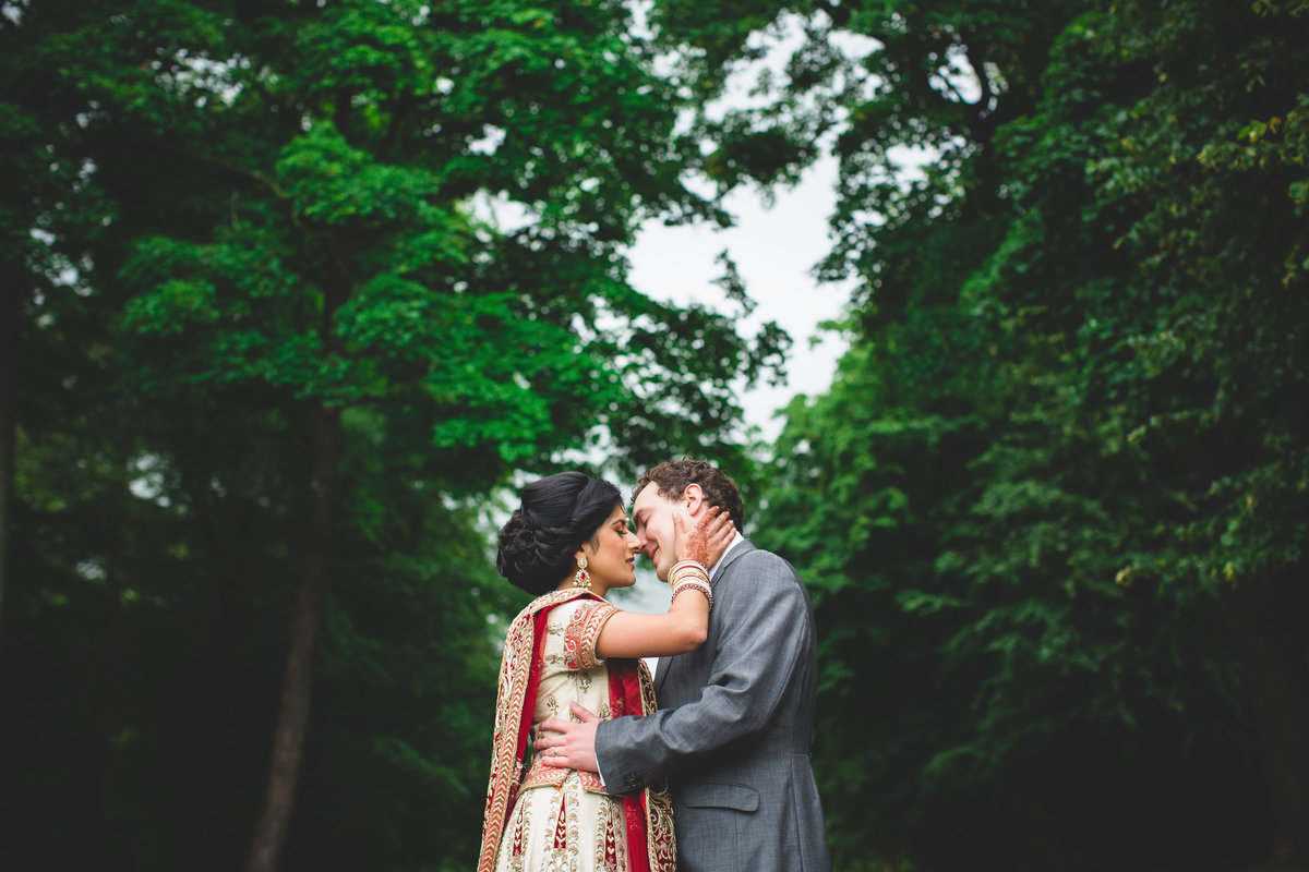 bride and groom kissing in woods