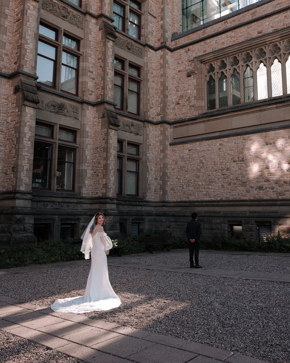 Bride looking back during her first look  while her future husband waits to turn around