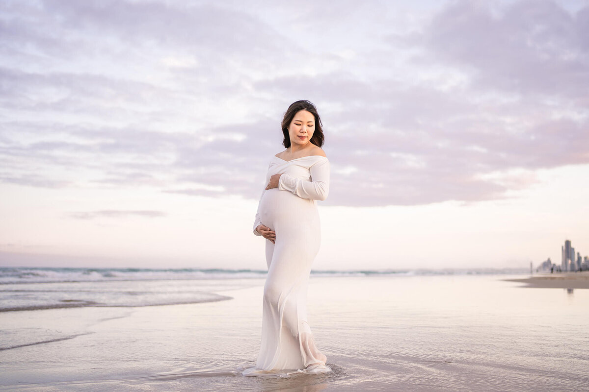 Gorgeous Mum posing elegantly for pregnancy photography on the beach in Gold Coast