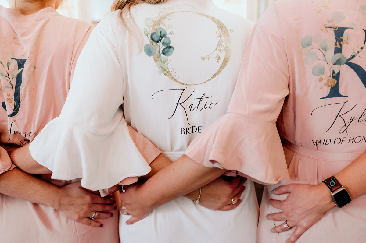 detail shot of bride and her bridesmaids wedding robes as they all stand together captured by Best Little Rock wedding photographer