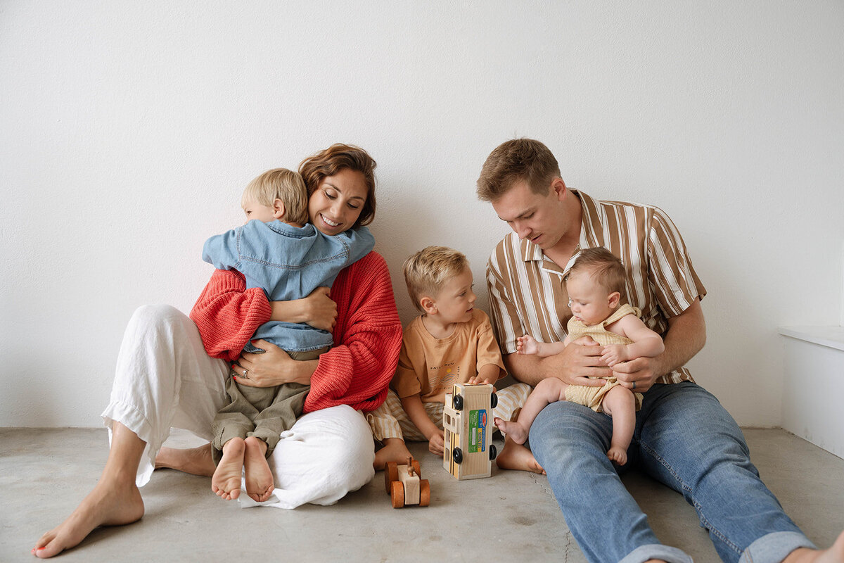 Minimalist newborn photography in an Orange County studio with soft light and a simple background.