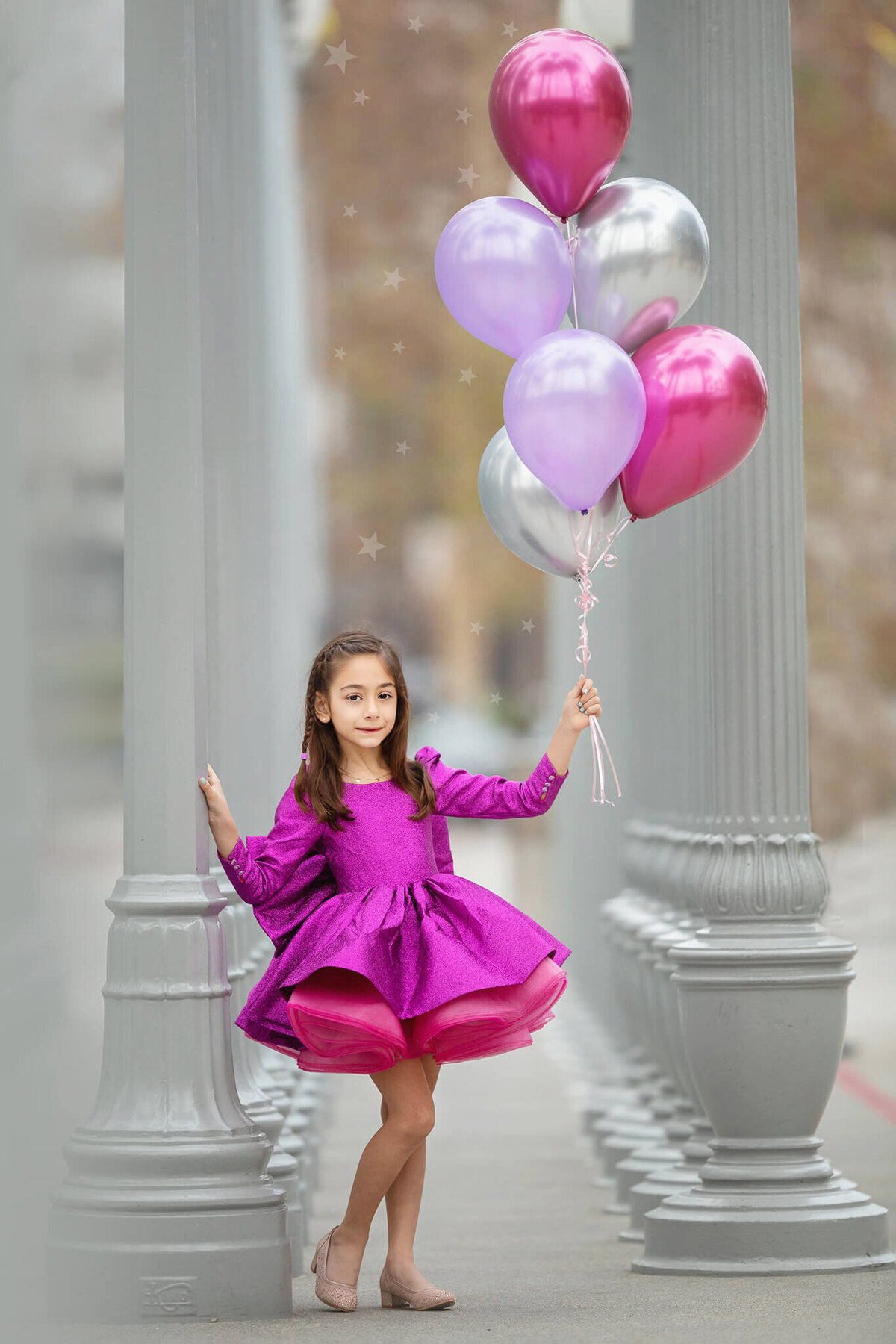 Girl holding birthday balloons for photoshoot at LACMA  by Elsie Rose Photography