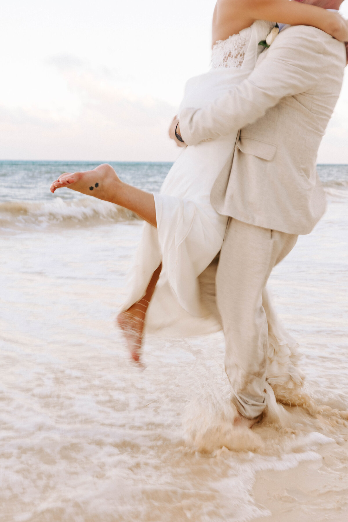 Bride and groom share intimate moments on the beach after their wedding Cancun, Mexico