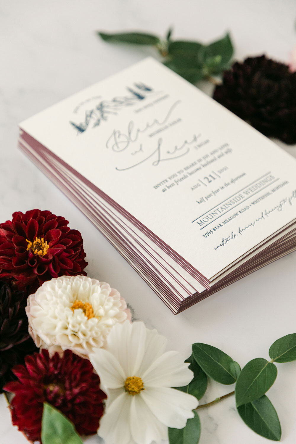 letterpress wedding invitation with burgundy painted edges and mountain detail