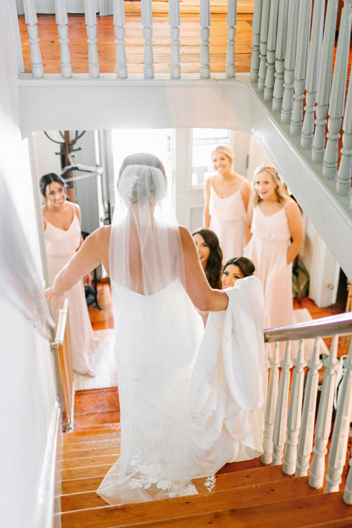 bridesmaids react to seeing bride in her wedding dress for the first time