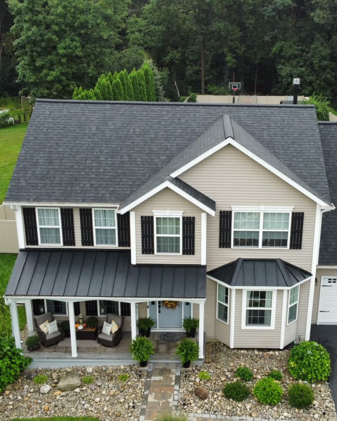 Residential roof replacement with Owens Corning Black Onyx asphalt shingles and black metal roofing