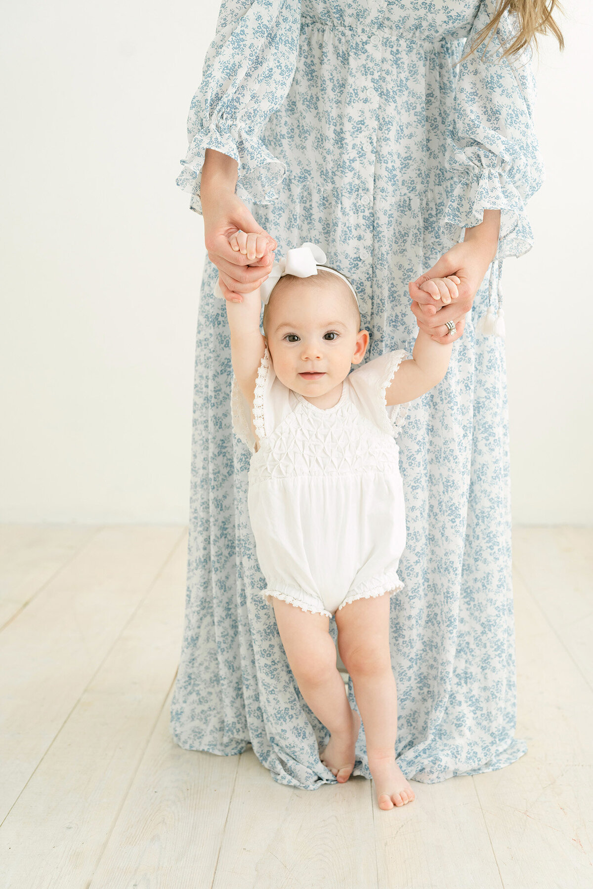 Oldham County mother holds daughter's hand during 1st birthday photos at Julie Brock Photography