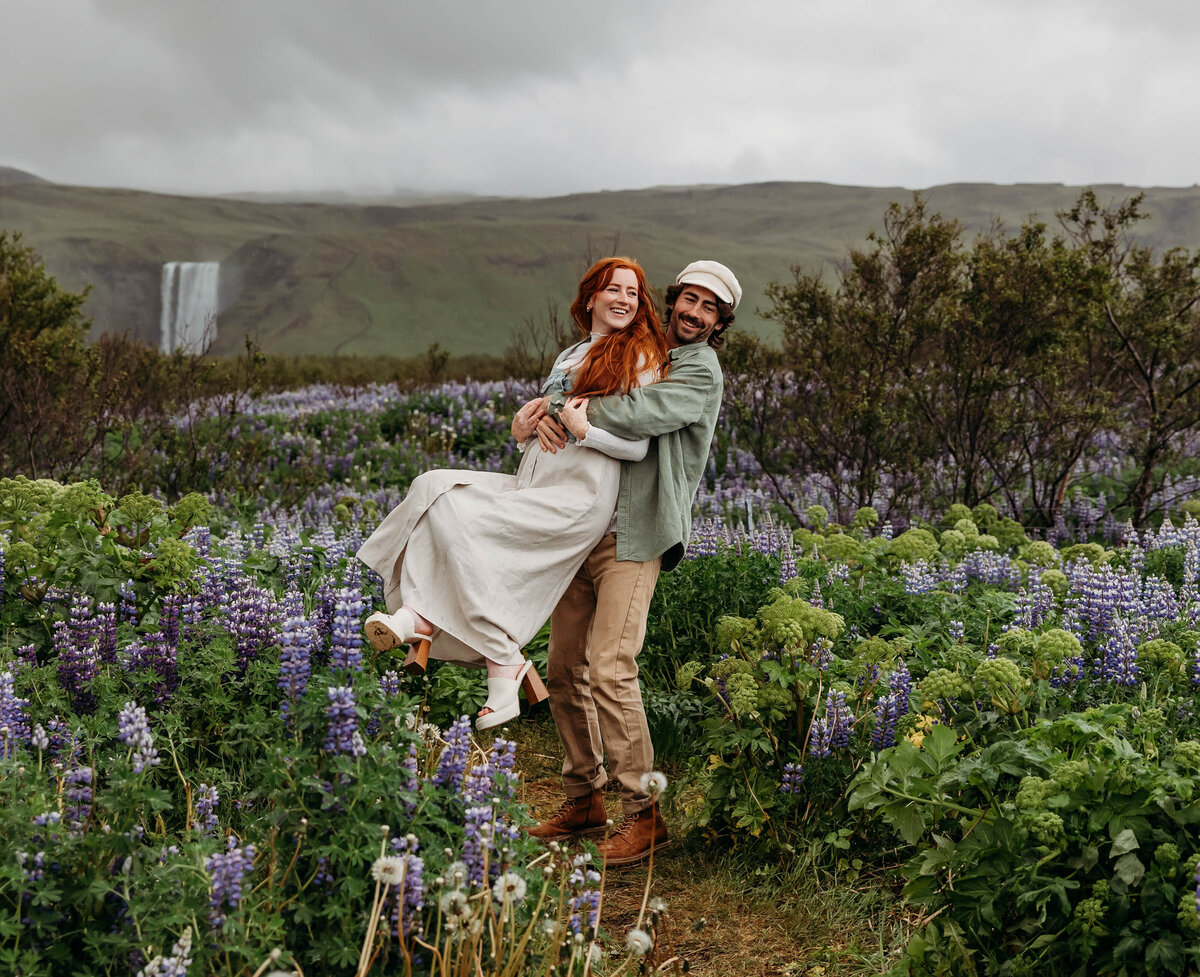 Couples session at Skogafoss waterfall, romantic Iceland destination photography.