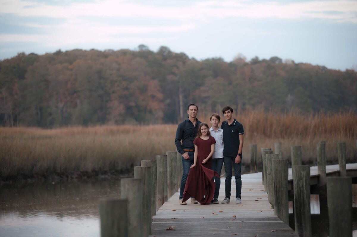 Family portrait on a fall dock edited with Wanderlight preset – natural soft light, earthy tones, and gentle contrast for lifestyle and storytelling photography.