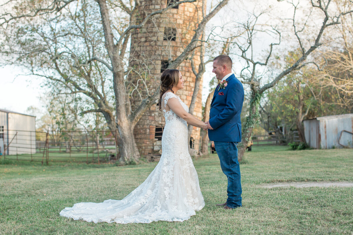 Colorado wedding photographer Stephanie Eddy captures a moment of the groom admiring his bride with a long gorgeous train