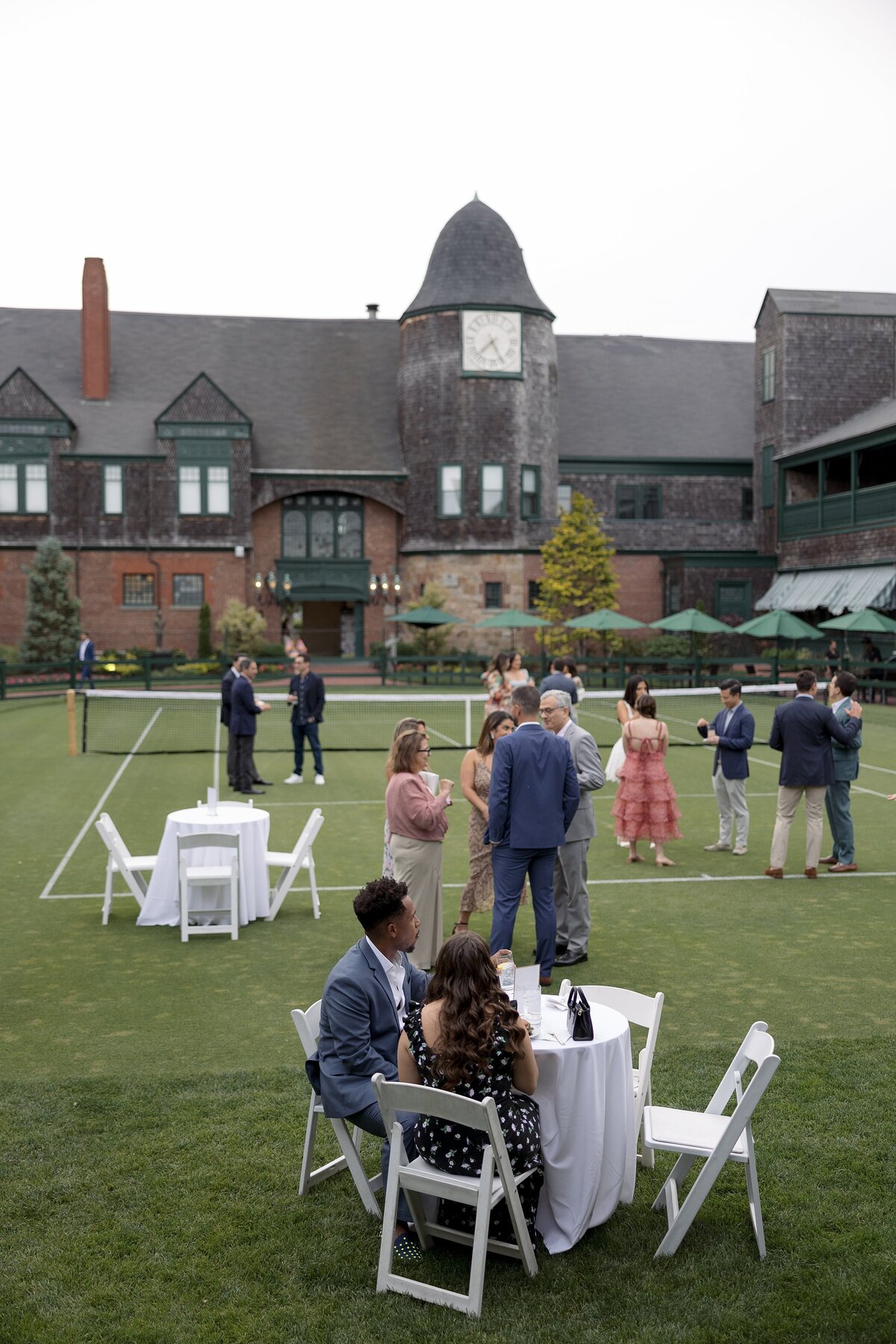 Guests mingle on the lawn of the Tennis Hall of Fame  in Newport during a welcome party. 