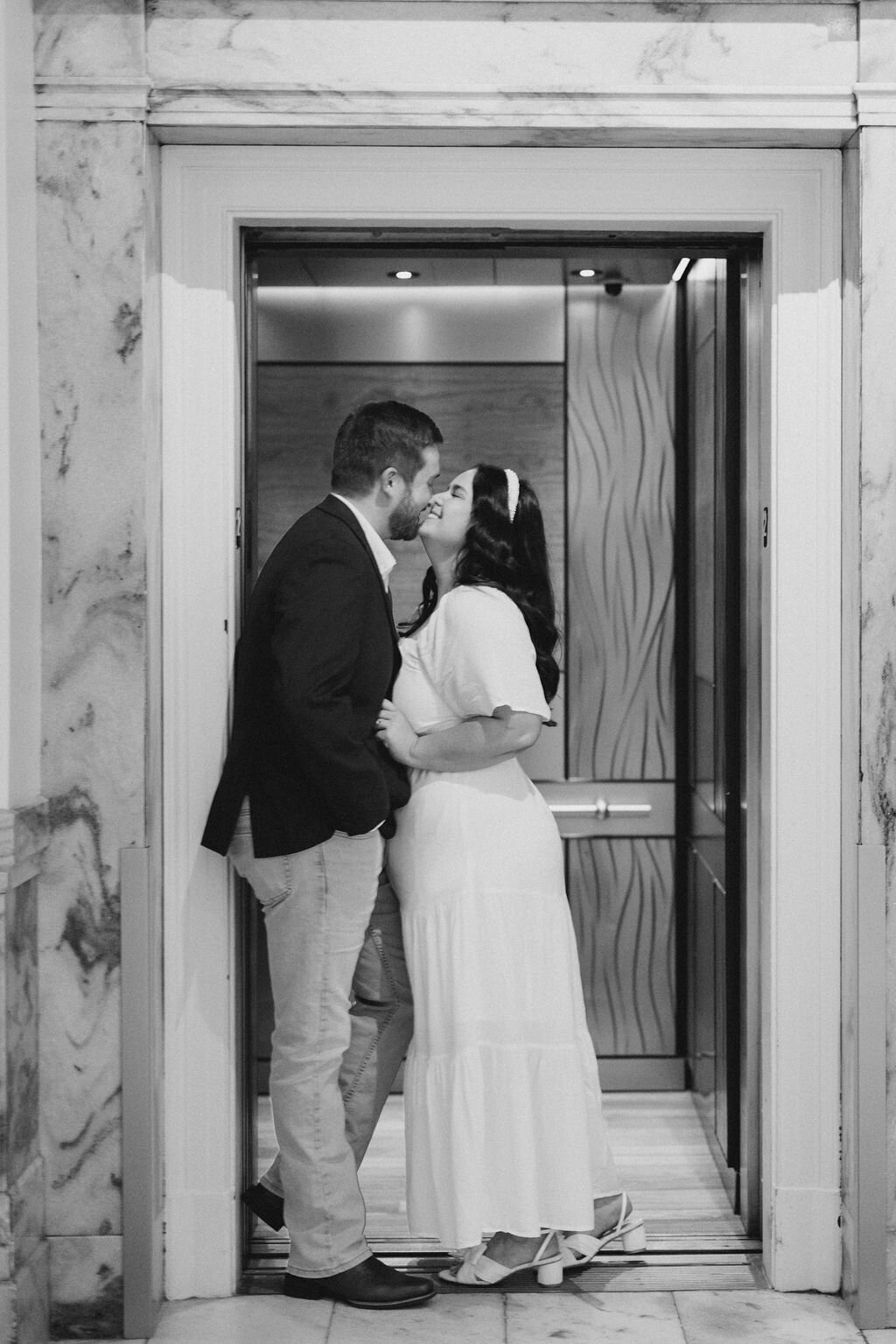 Man kisses woman as elevator doors are about to close