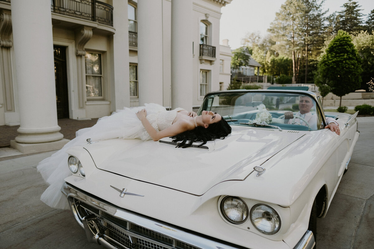 bride and groom looking at each other in a vintage car