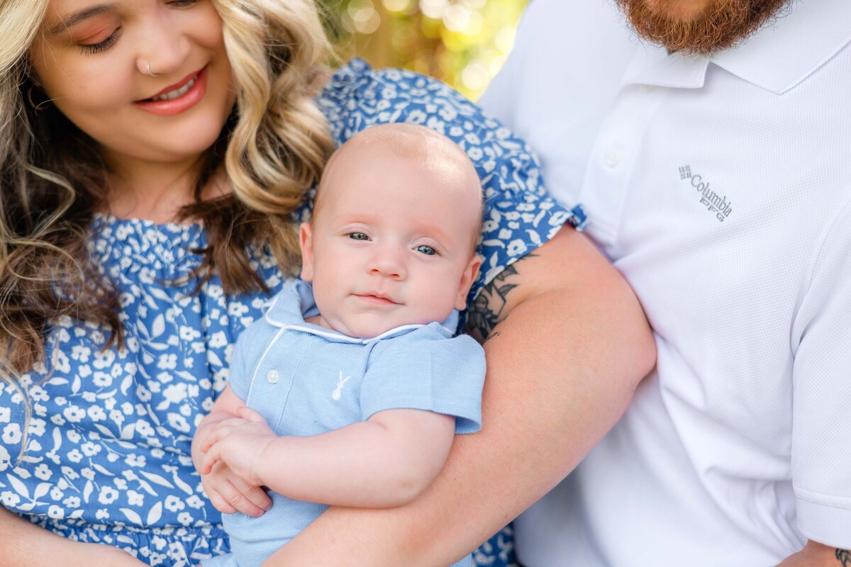 mom, dad, and 4 month old boy wearing blue and white outfits for their family session at woodlawn plantation and gardens in guyton, ga