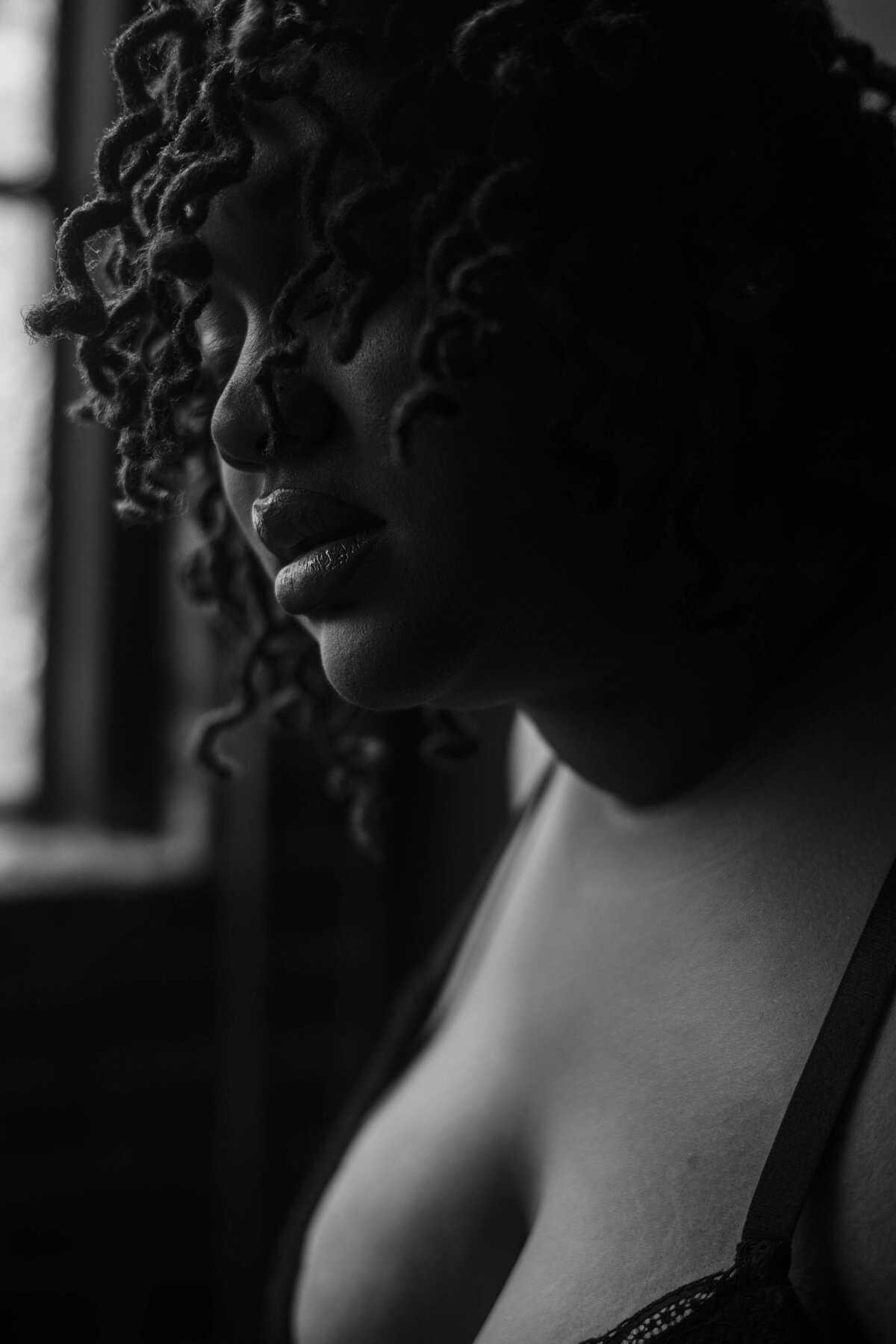 close up of a plus size woman during a boudoir shoot with her hair cascading down her face