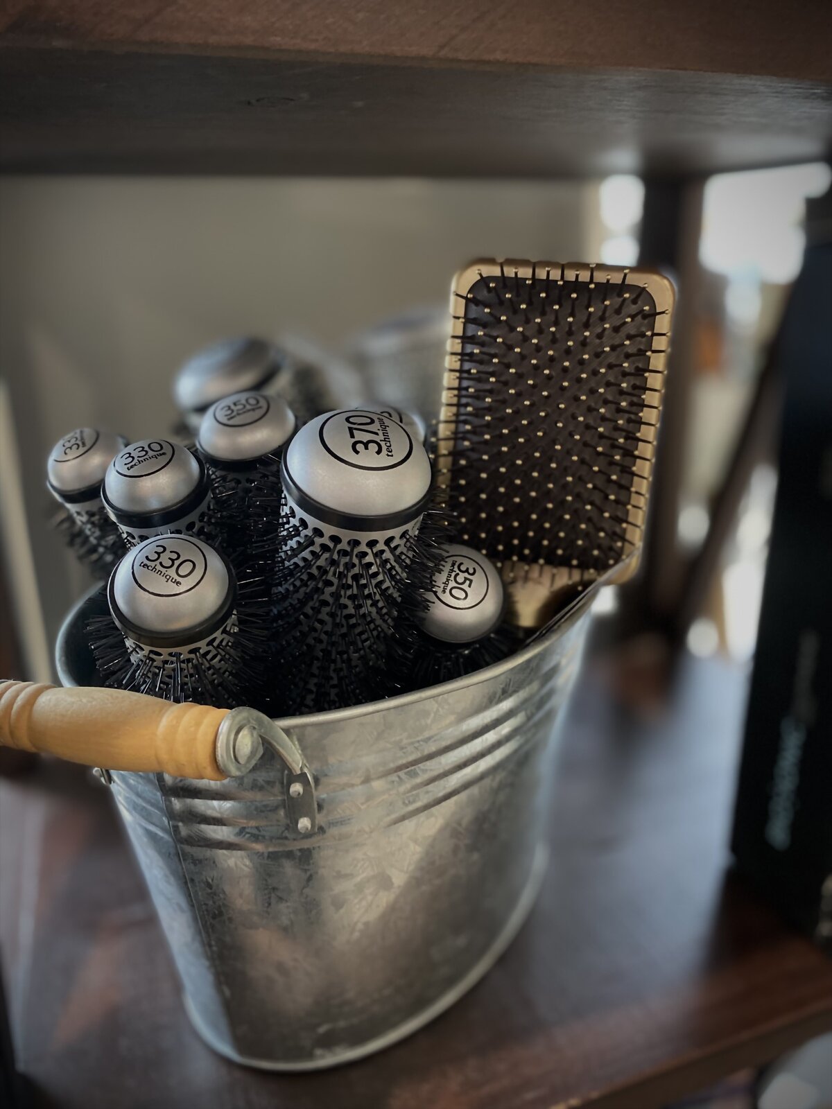 hair brushes in tin bin