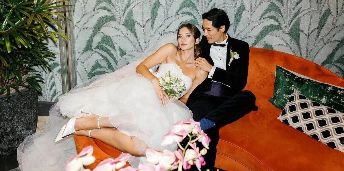 Sophisticated couple posing at their Miami wedding with timeless architecture in the backdrop, by Claudia Amalia.