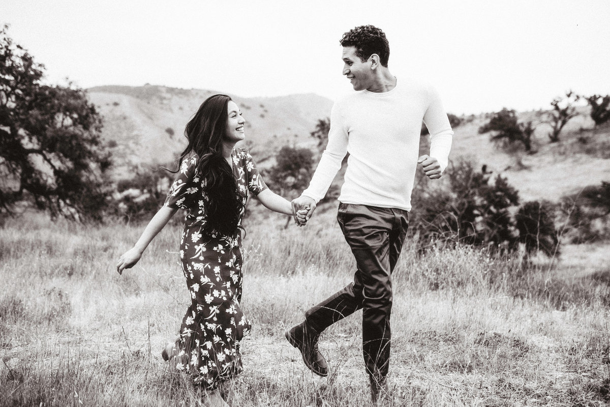 Engagement Photograph Of  Man And Woman Smiling At Each Other While Holding Hands Los Angeles