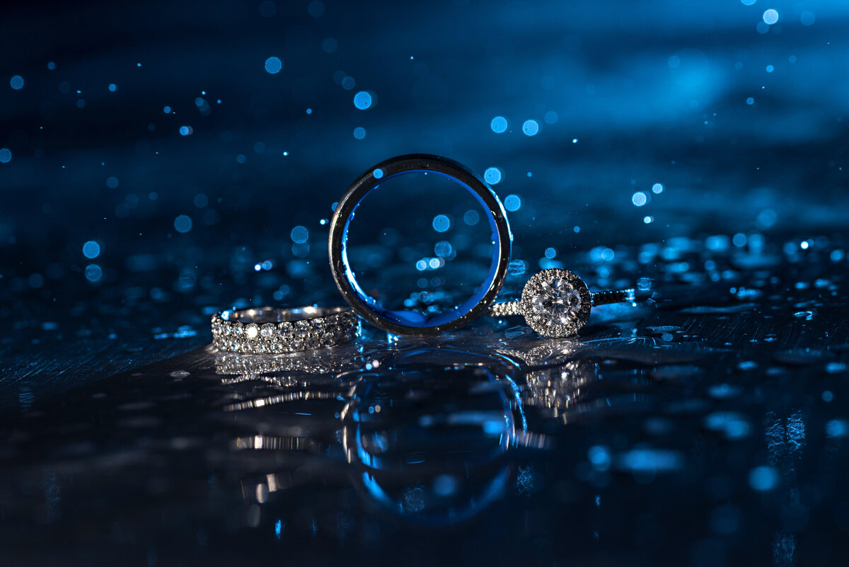 Wedding rings in blue rain.