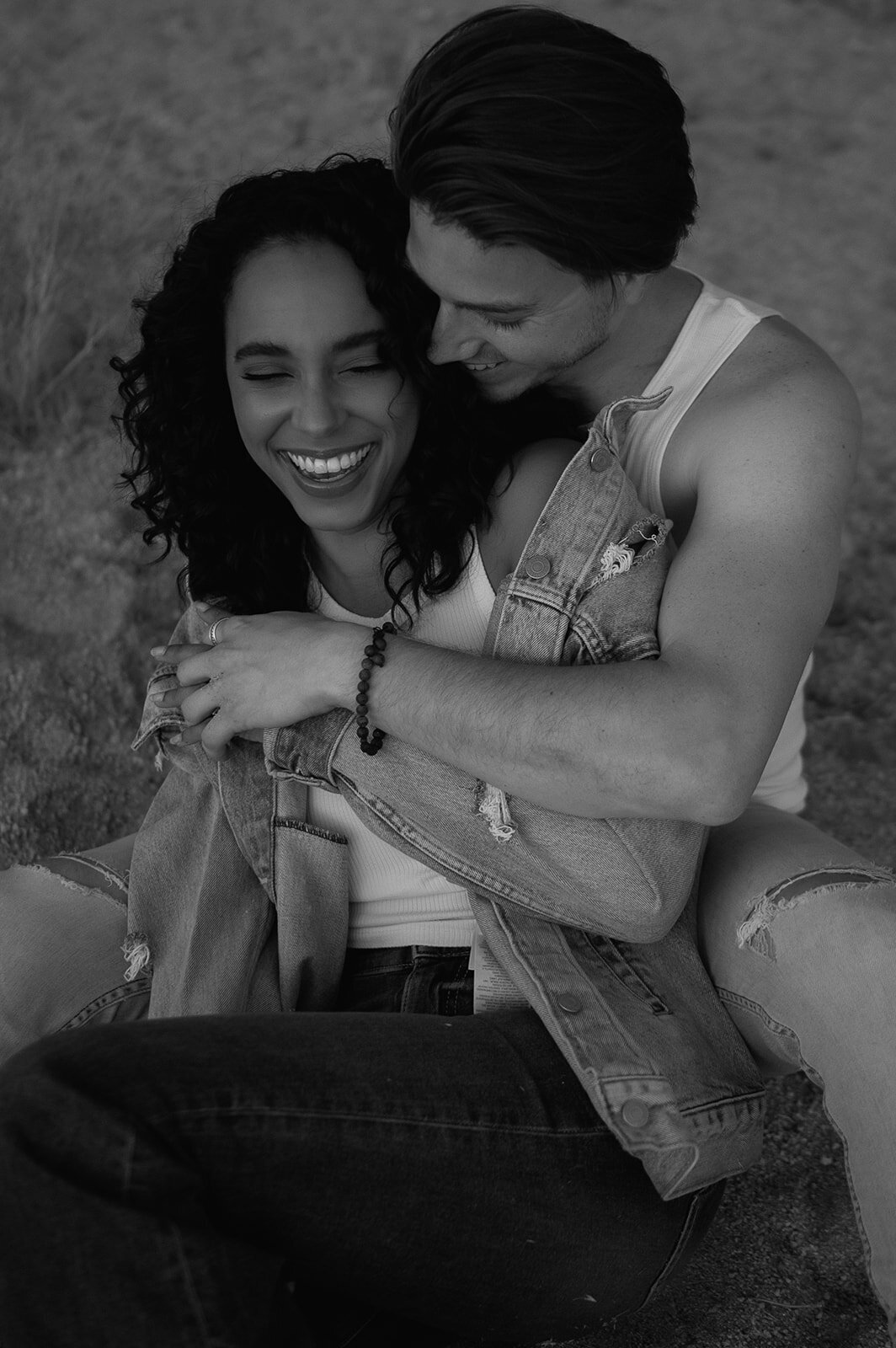 couple sitting on rock during couples photos