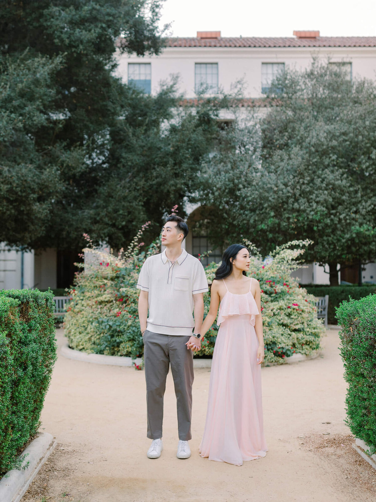engaged couple posing in front of courtyard of pasadena city hall
