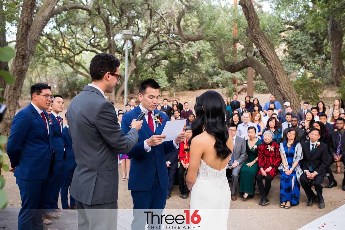 Groom reads his vows to his Bride